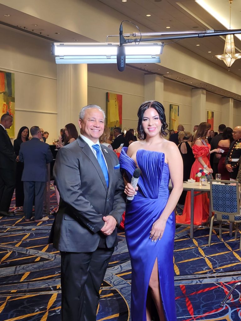 Victor with a woman in blue dress